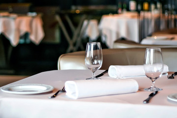 Wine glasses on the table. Restaurant serving. Waiting customers. Decorated table in the cafe. An empty wine glass.