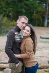 Loving couple hugging on the rocky beach