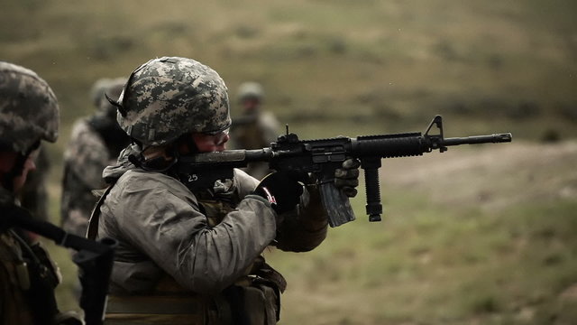Soldier shooting an M4 rifle