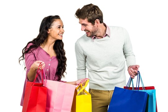 Stylish couple holding shopping bags 