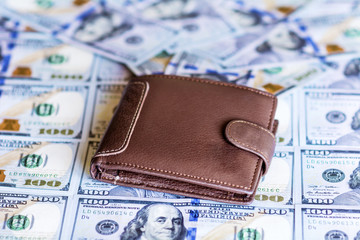 leather  wallet on stacks of the United States dollars