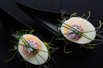 Appetizer on fingerspoon egg with caviar