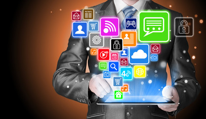 Business man using tablet PC with social media icon set