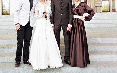 Obraz na płótnie Canvas bride and groom with wedding guests 