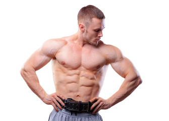 Fototapeta premium Muscular man with lifting belt posing over white isolated background