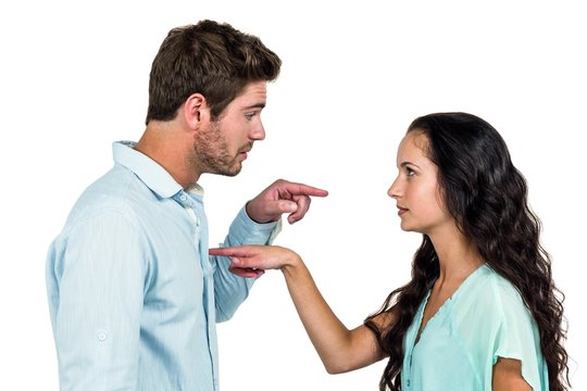 Couple pointing each other having argument