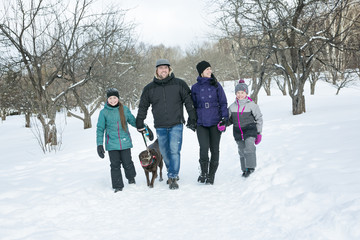 Happy parents and their kids in winterwear 