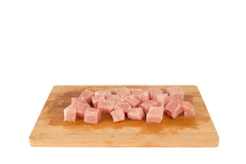 Raw piece of meat on a wooden board on a white background
