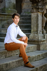 young cute guy sitting on the porch