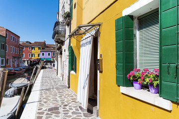  touristic famous street with colorful houses . Burano island, province of Venice, Italy