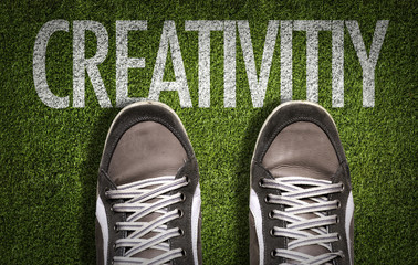 Top View of Sneakers on the grass with the text: Creativity