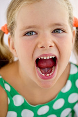 Little girl with falling tooth 