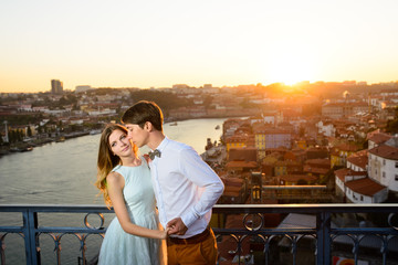 Happy young couple stands on background Porto