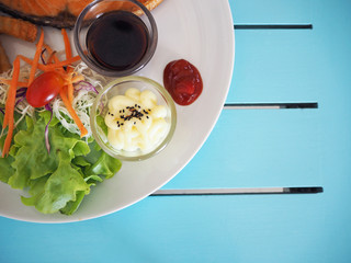 Salad with sauce on white plate