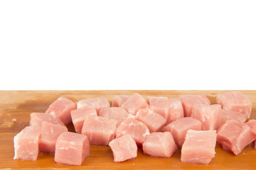 Raw piece of meat on a wooden board on a white background