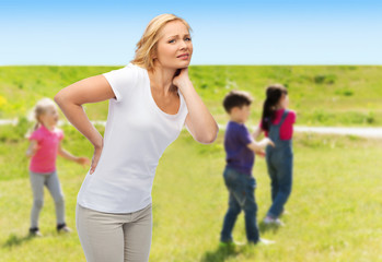 Fototapeta premium woman suffering from backache over group of kids