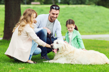 happy family with labrador retriever dog in park