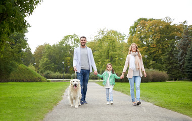 happy family with labrador retriever dog in park