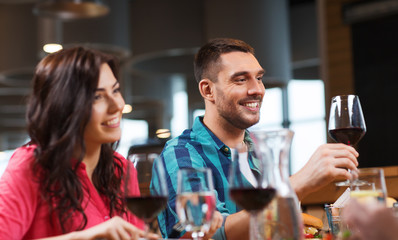 friends clinking glasses of wine at restaurant