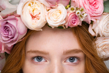 Obraz na płótnie Canvas Closeup of beautiful woman eyes in flower wreath