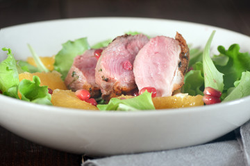 Roasted duck breast and salad with orange and pomegranate