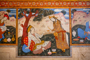 Couple in love drinking tea in the garden on the mural of palace Chehel Sotoun