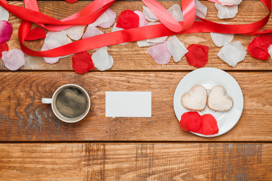 The red  ribbon on  wooden background with a cup of coffee