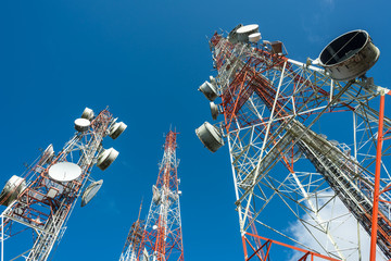 three big radio mast with blue sky