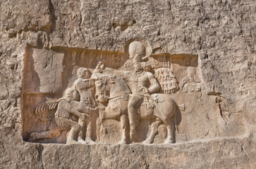 Fototapeta na wymiar Historical relief carved between 239 - 70 AD about triumph of king Shapur I the Great, Persian rulers.