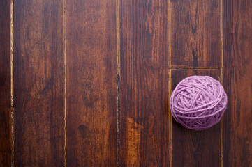 Lilac skein over wooden background