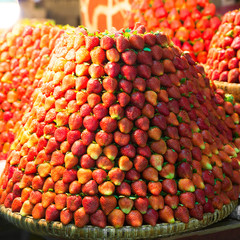 Row upon row of fresh, juicy  garden strawberries for retail sal
