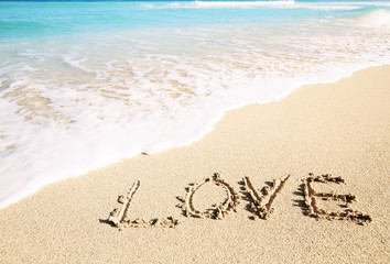 Fototapeta na wymiar Love inscribed in the sand of a beach