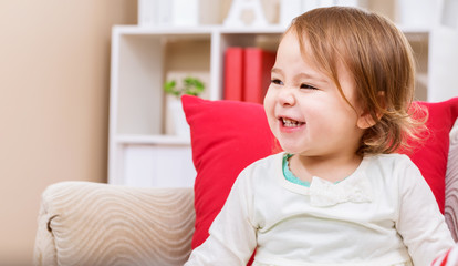 Fototapeta premium Happy toddler girl smiling in her house
