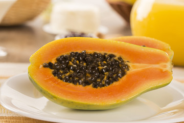 breakfast table with papaya and coffee