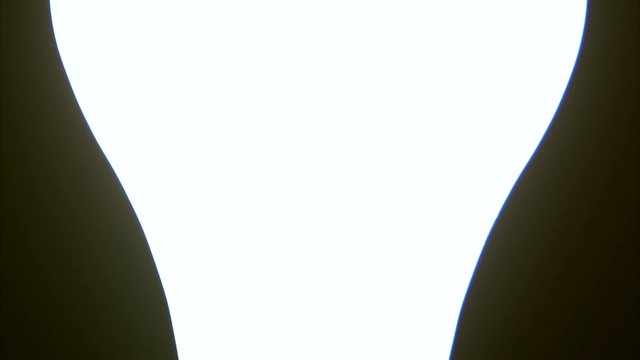 Close up pan of a lit lightbulb.