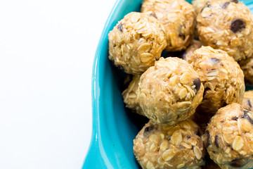 energy balls in a blue bowl on a white background