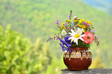 hand made vase with colorful spring wild flowers