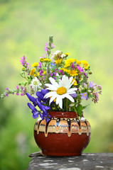 hand made vase with colorful spring wild flowers