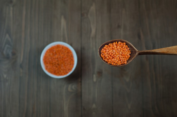 Red Lentils in a Wooden Spoon.