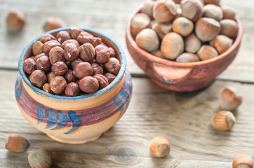 Rustic bowls of hazelnuts on the wooden table