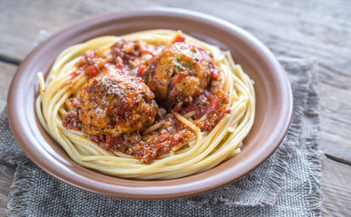 Turkey meatballs with pasta on the wooden background