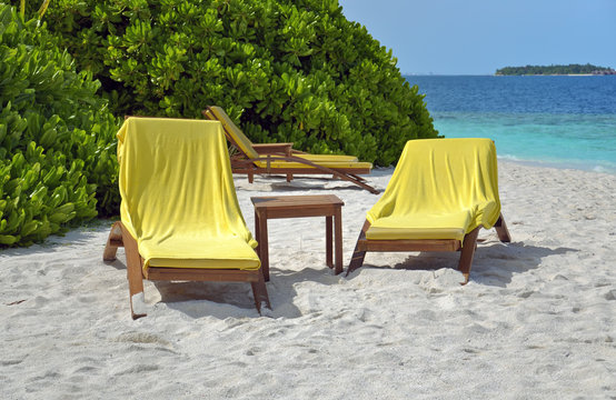 Fototapeta sun loungers on beach of tropical island