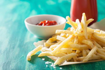 french fries with ketchup over green background