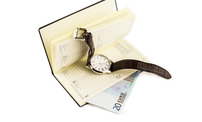 The euro opened notebook and wristwatch