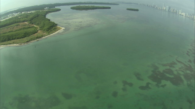 Aerial shot of the ocean and islands off the coast of Miami.