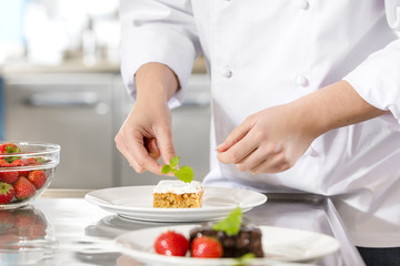 Chef decorate dessert cake with lemon leaf