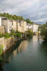 riverbank with old houses mirrored at surface of the river in Oloron-Sainte-Marie, Pyrenees, France 
