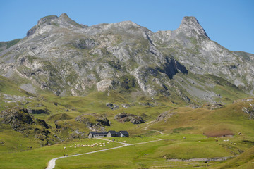 Fototapeta na wymiar rocky ridge of Pyrenees in France at border with Spain with pasture and chalet below the hills