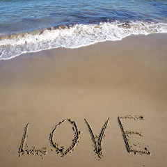 Word love written on sand