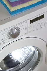 Washing machine , White washing machine with towels on top, close-up